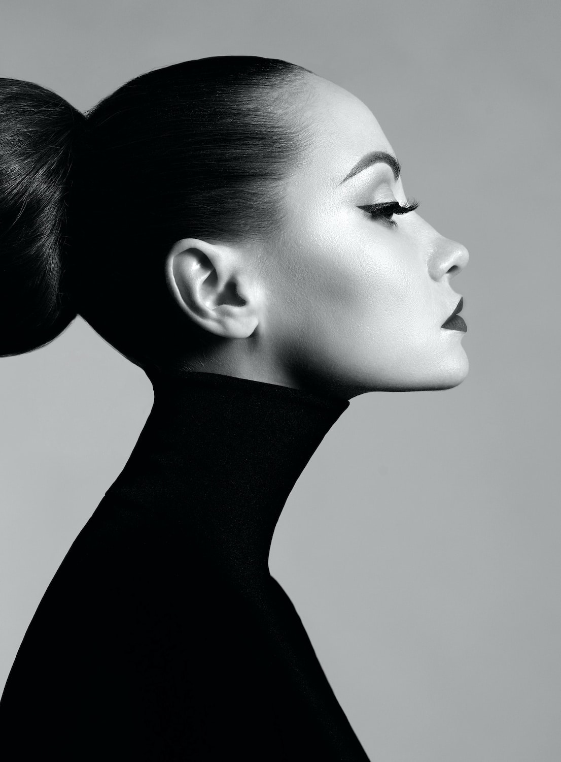 black and white image of woman with large bun copy