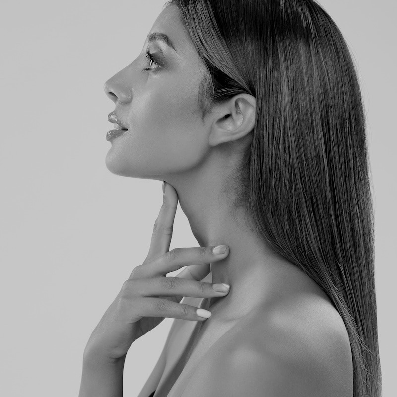 woman with her hands on her neck