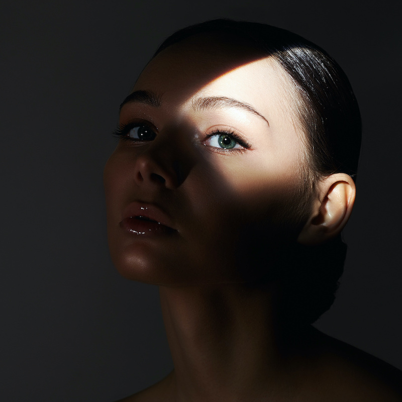 upper eyelids young woman with shadows across her face copy